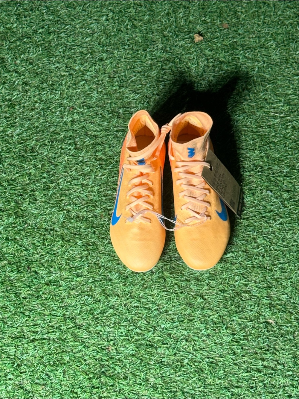 Nike Orange Soccer Cleats with Blue Swoosh Accents